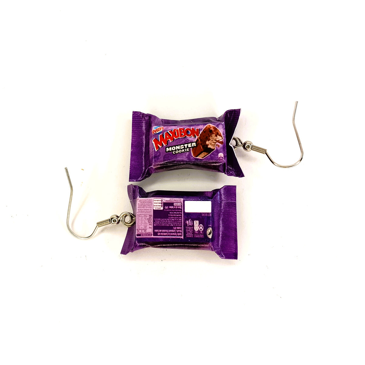 A pair of novelty earrings designed to look like miniature ice cream bars, featuring purple wrappers with 'Maxibon Monster Cookie' branding and silver-tone hook clasps, shown on a plain white background.