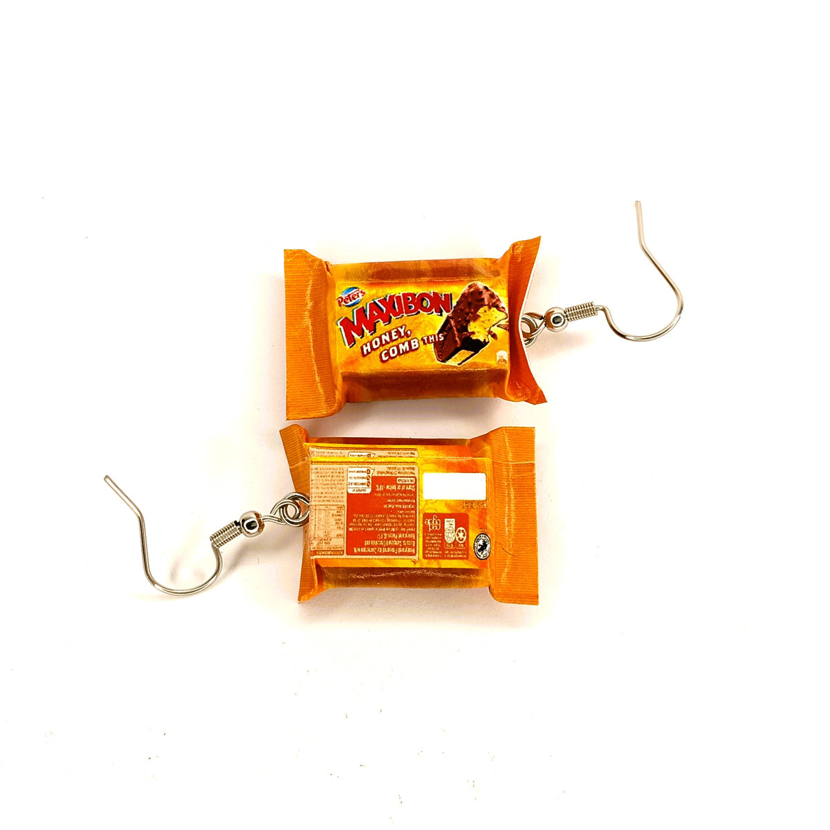 A pair of novelty dangle earrings designed to look like miniature wrapped Maxibon Honeycomb ice cream sandwiches, featuring orange wrappers with printed graphics and silver-tone hook clasps, shown on a plain white background.