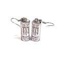 Monster energy drink can earrings on a white background