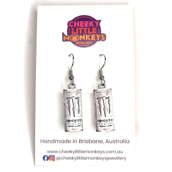 Monster energy drink can-shaped earrings on a Cheeky Little Monkeys branded card.