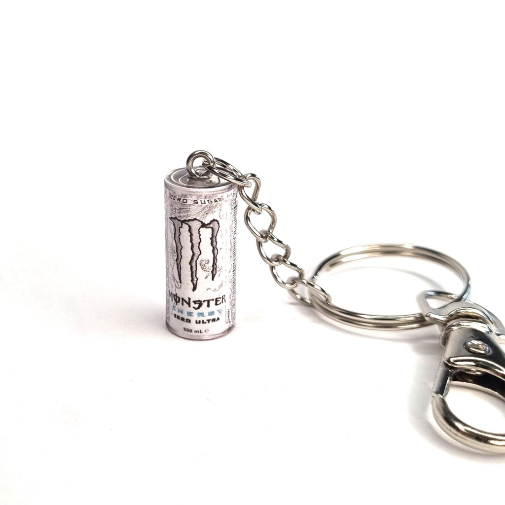 Metal keychain shaped like a Monster Energy drink can on a white background