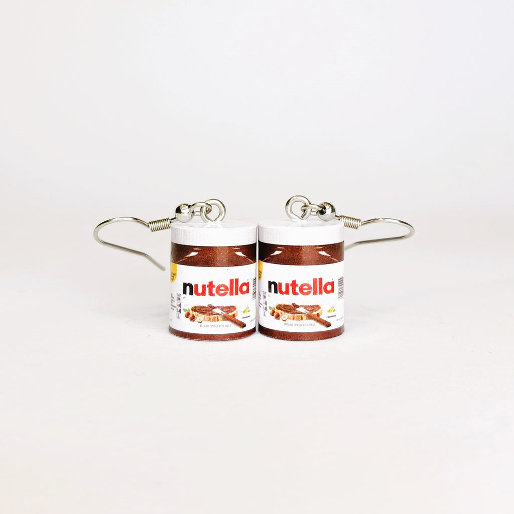 A pair of earrings designed to look like two small Nutella jars, with silver-tone wire hooks extending from the lids, shown on a plain white background.