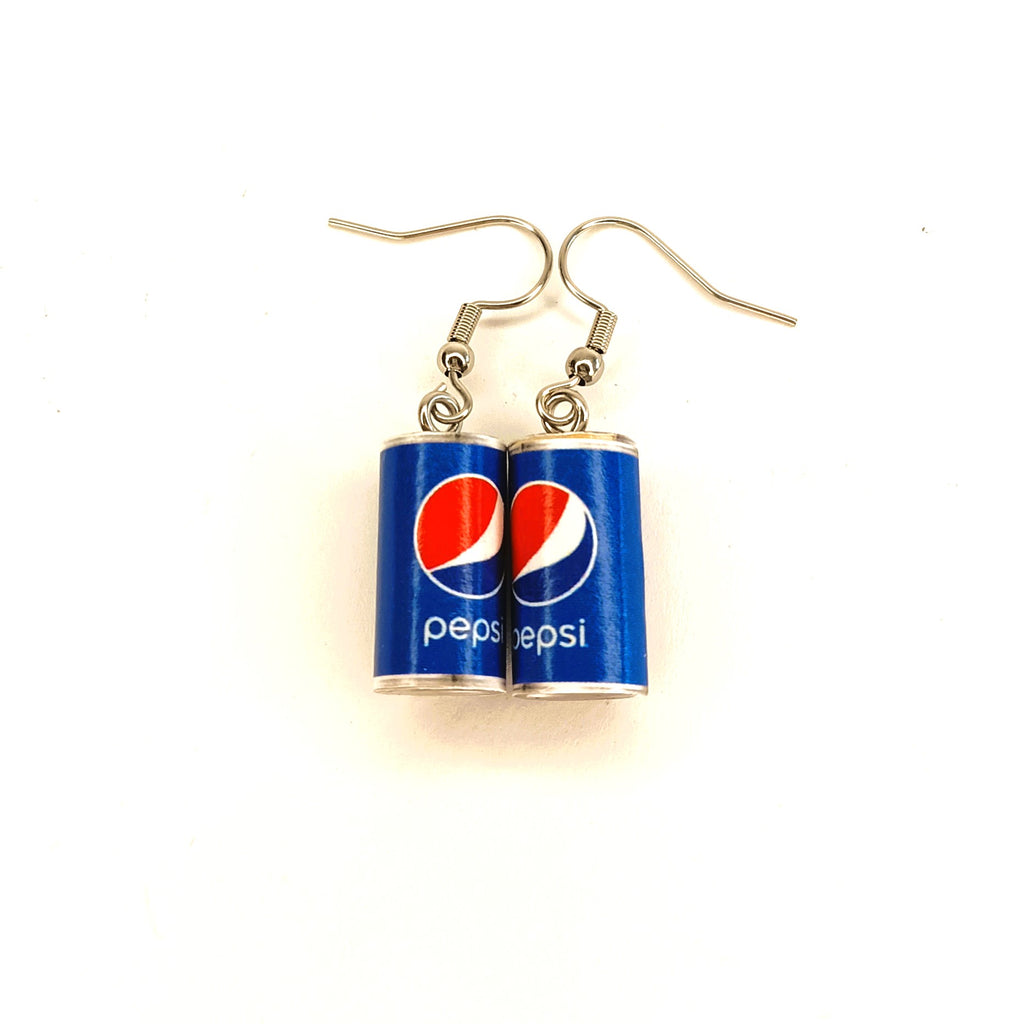 A pair of earrings shaped like Pepsi cans, featuring the blue can design with the red and white logo and white 'Pepsi' text, hanging from silver fishhook wires on a white background.