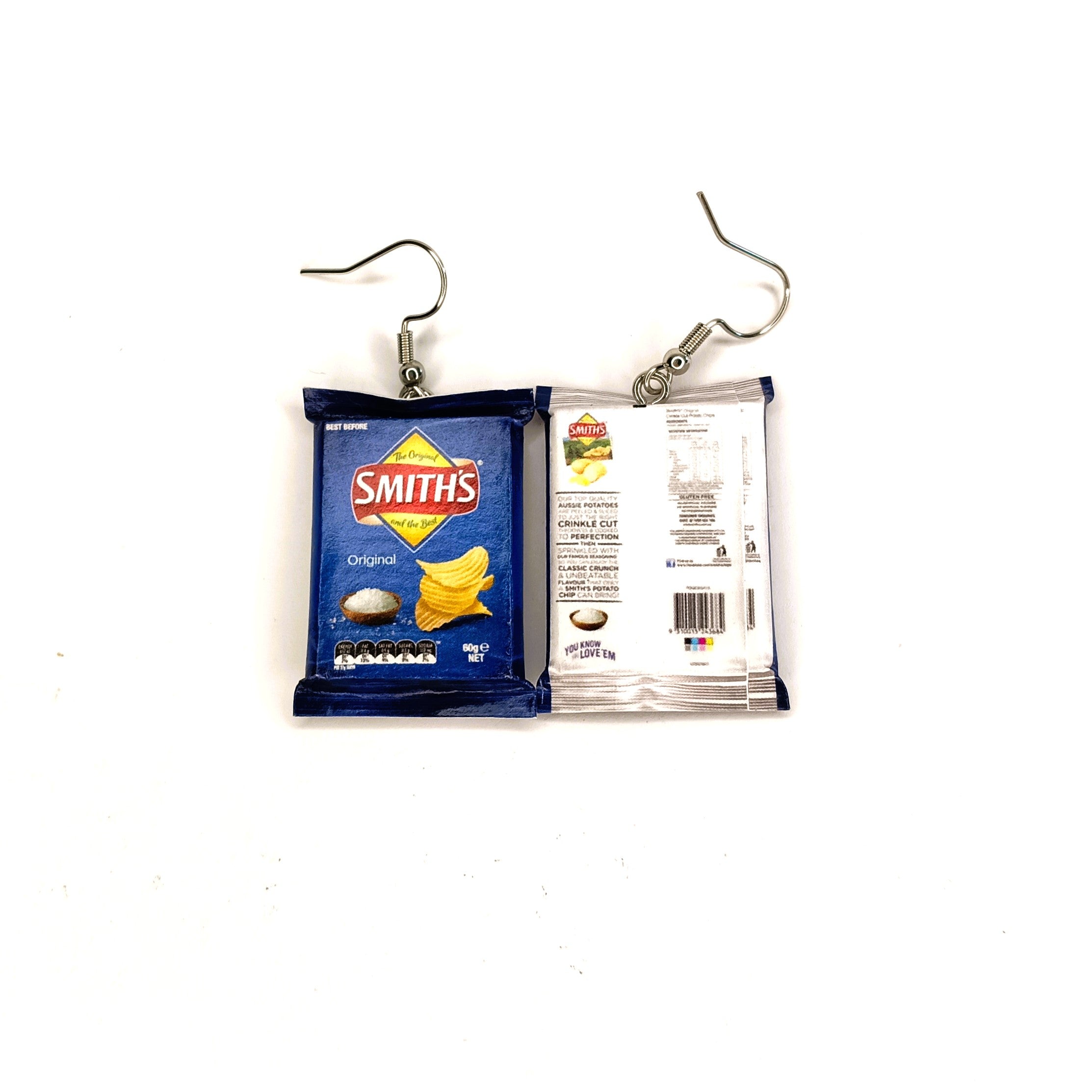 A pair of novelty earrings shaped like miniature Smith's potato chips, featuring one front-facing blue chip packet and one back-facing packet, suspended from silver fishhook ear wires on a white background.
