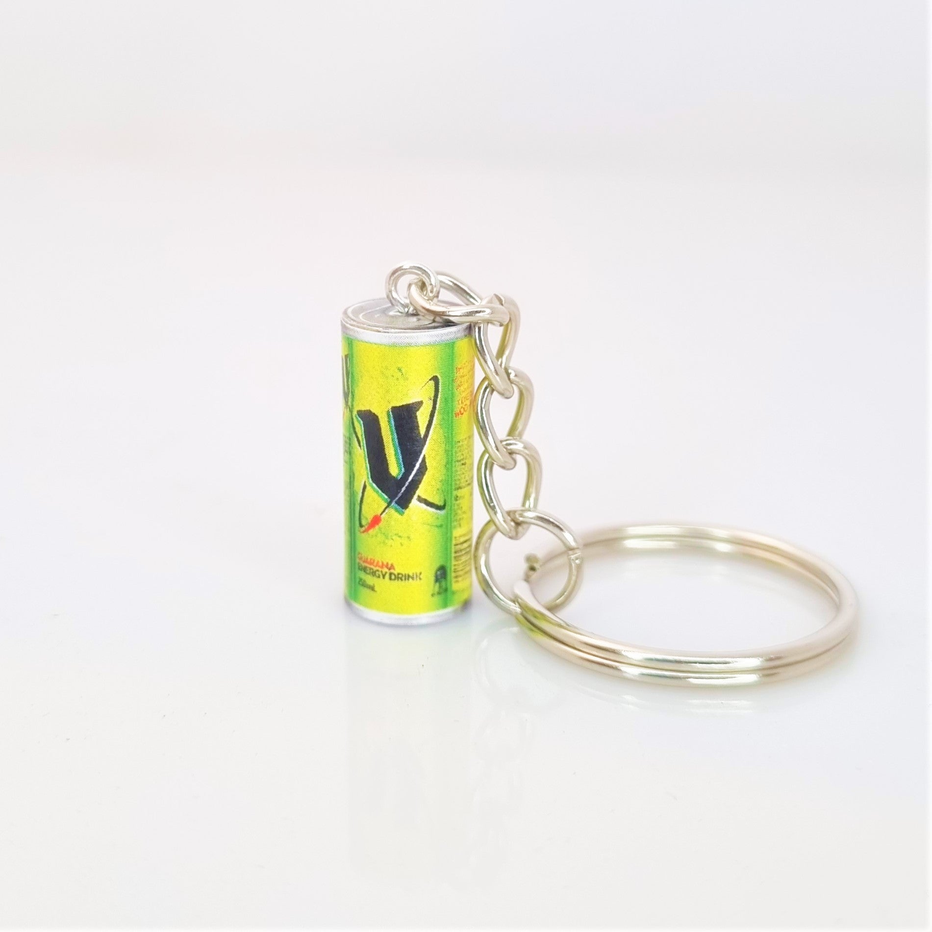 Miniature V energy drink keyring against a white background